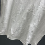 White Dior short-sleeve T-shirt front with textured embossed pattern across the body