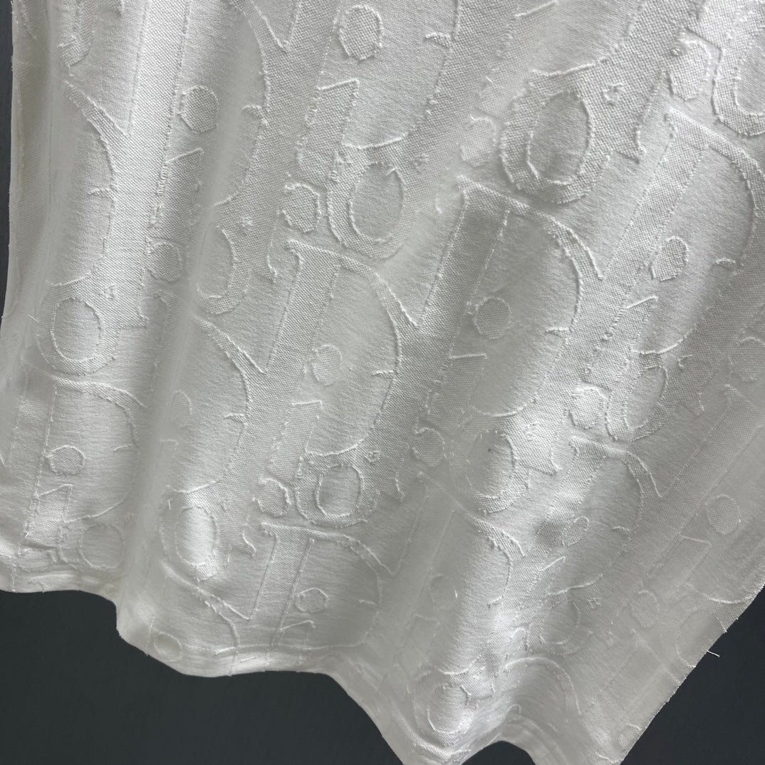 White Dior short-sleeve T-shirt front with textured embossed pattern across the body
