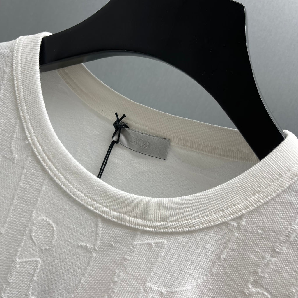 White Dior short-sleeve T-shirt neckline detail with ribbed crew collar and embossed fabric