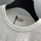 White Dior short-sleeve T-shirt neckline detail with ribbed crew collar and embossed fabric