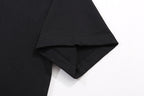 Black T-shirt hem with visible stitching and folded side edge