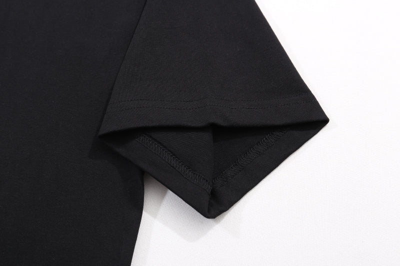 Black T-shirt hem with visible stitching and folded side edge