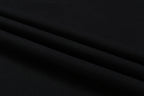 Black fabric garment with smooth woven texture