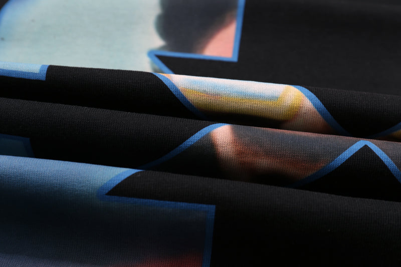 Black fabric garment with blue striped trim and pale panel details