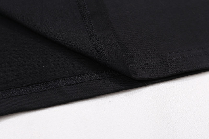 Black T-shirt close-up of side seam and hem stitching