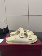 Gucci women's cream slide sandal with double straps and ornate gold-tone buckle