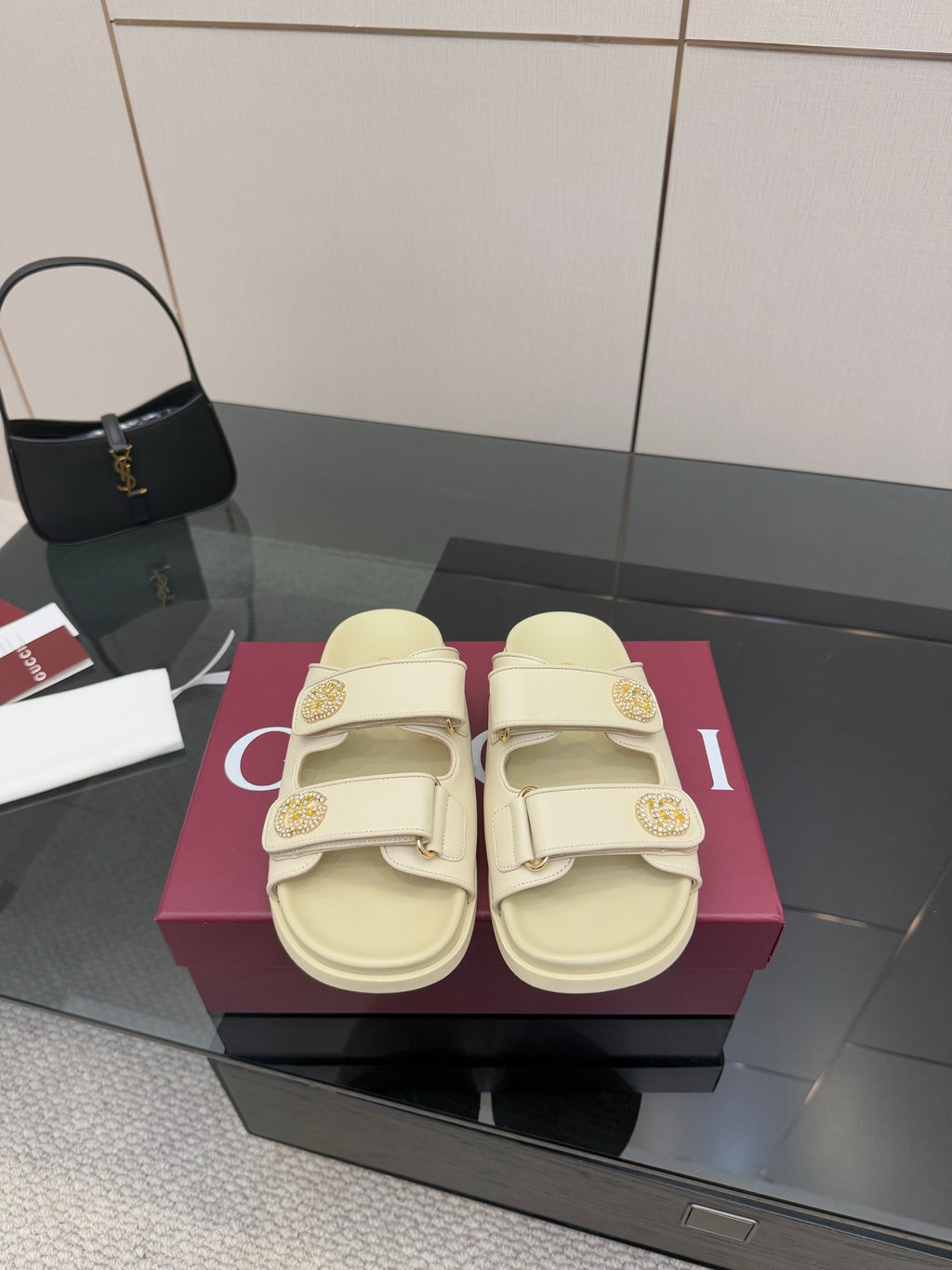 Gucci women's cream slide sandals with double buckles and gold-tone logo detailing
