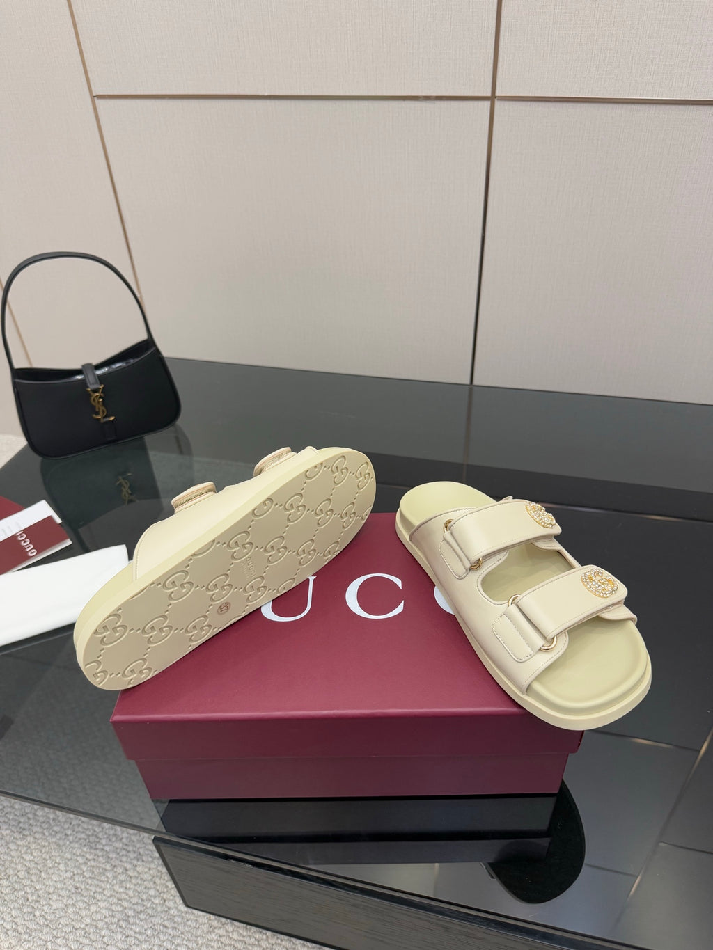 Gucci women's cream slide sandals with signature-pattern footbed and two strap buckles
