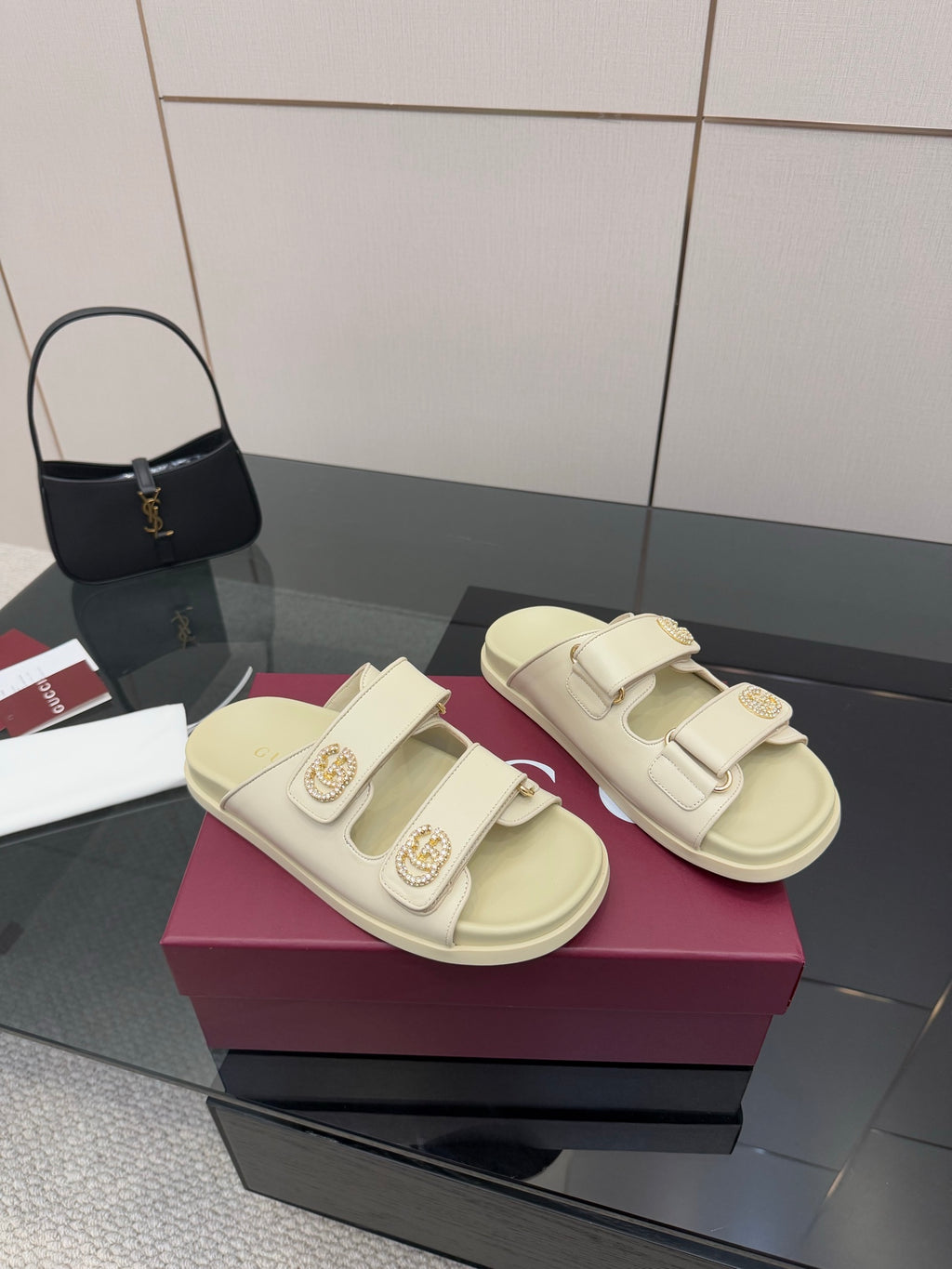 Gucci women's cream slide sandals with two adjustable straps and gold-tone buckle