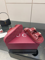 Red Gucci slide sandals with embossed GG pattern footbed and double strap