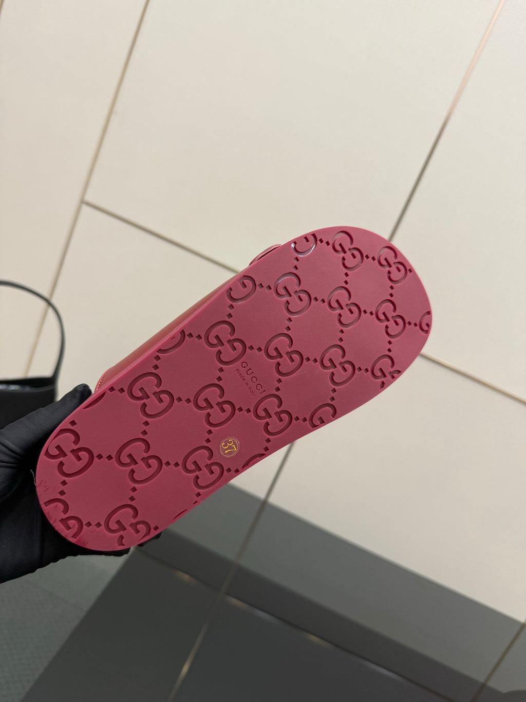 Red Gucci slide sandal outsole with GG pattern and textured grip