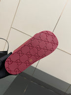 Red Gucci slide sandal outsole with GG pattern and textured grip