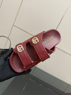 Red Gucci slide sandals, footbed view with embossed letters and double straps