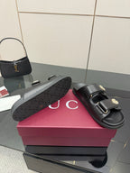 Gucci ladies black slide sandal with textured GG outsole pattern detail
