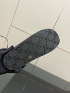 Gucci ladies black slide sandal outsole with dark GG monogram pattern