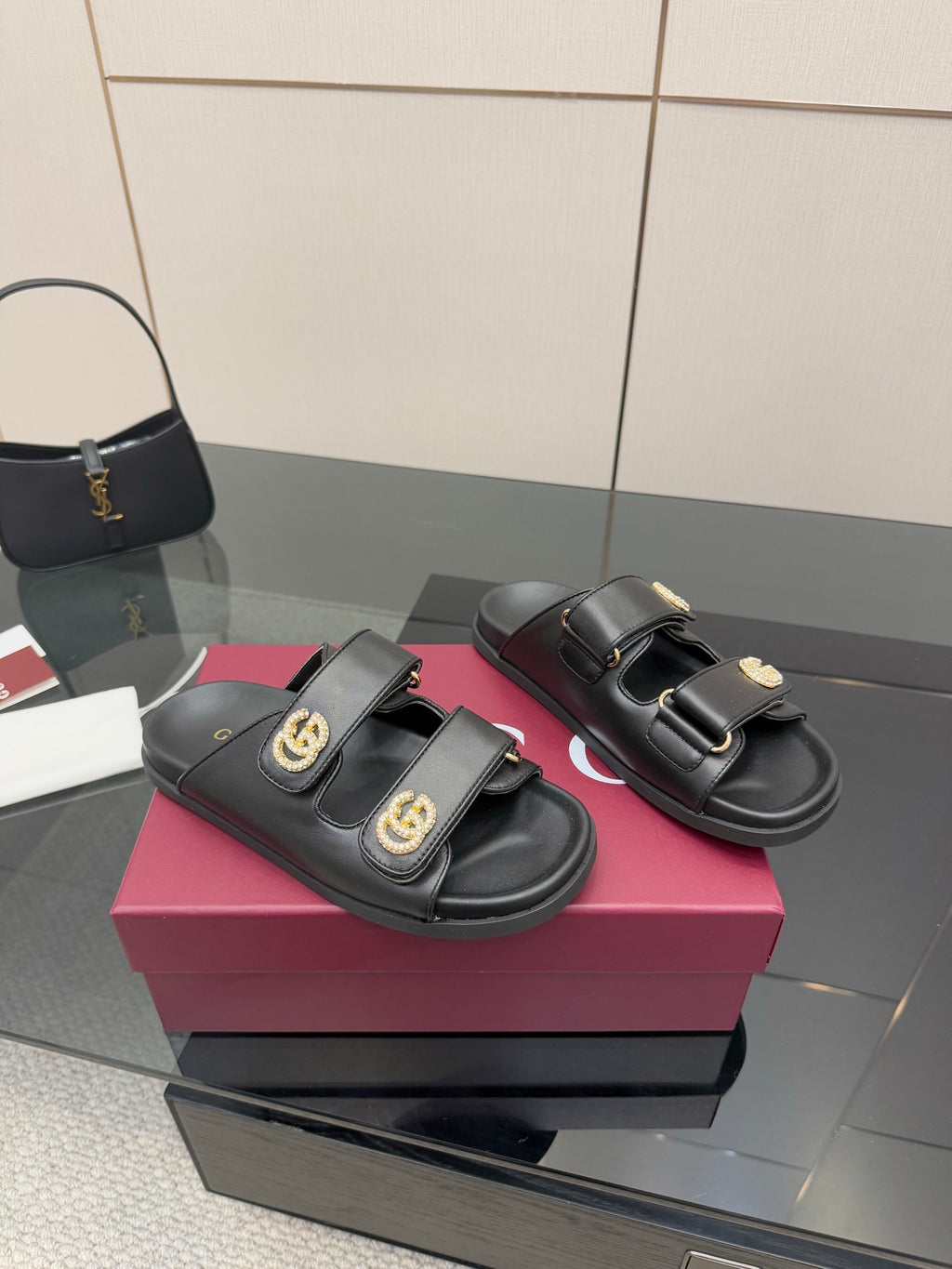 Gucci ladies black slide sandals with two adjustable straps and gold G buckles