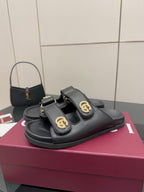 Gucci ladies black slide sandals, rounded toe with gold G buckle strap