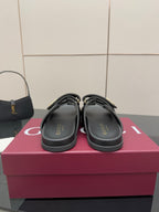 Gucci ladies black slide sandals showing GUCCI logo on footbeds