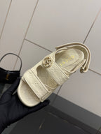 Cream slide sandal with adjustable strap and metal buckle, side view