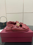 Red Gucci embossed leather-look sandals with logo buckle strap, top view