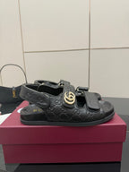 Gucci women's black patterned slide sandals with gold double-G buckle