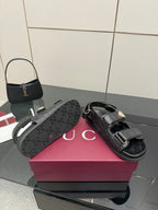 Gucci women's black logo-pattern sandals with gold buckle and wide front strap
