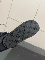 Gucci women's black sandals outsole with logo pattern and textured tread