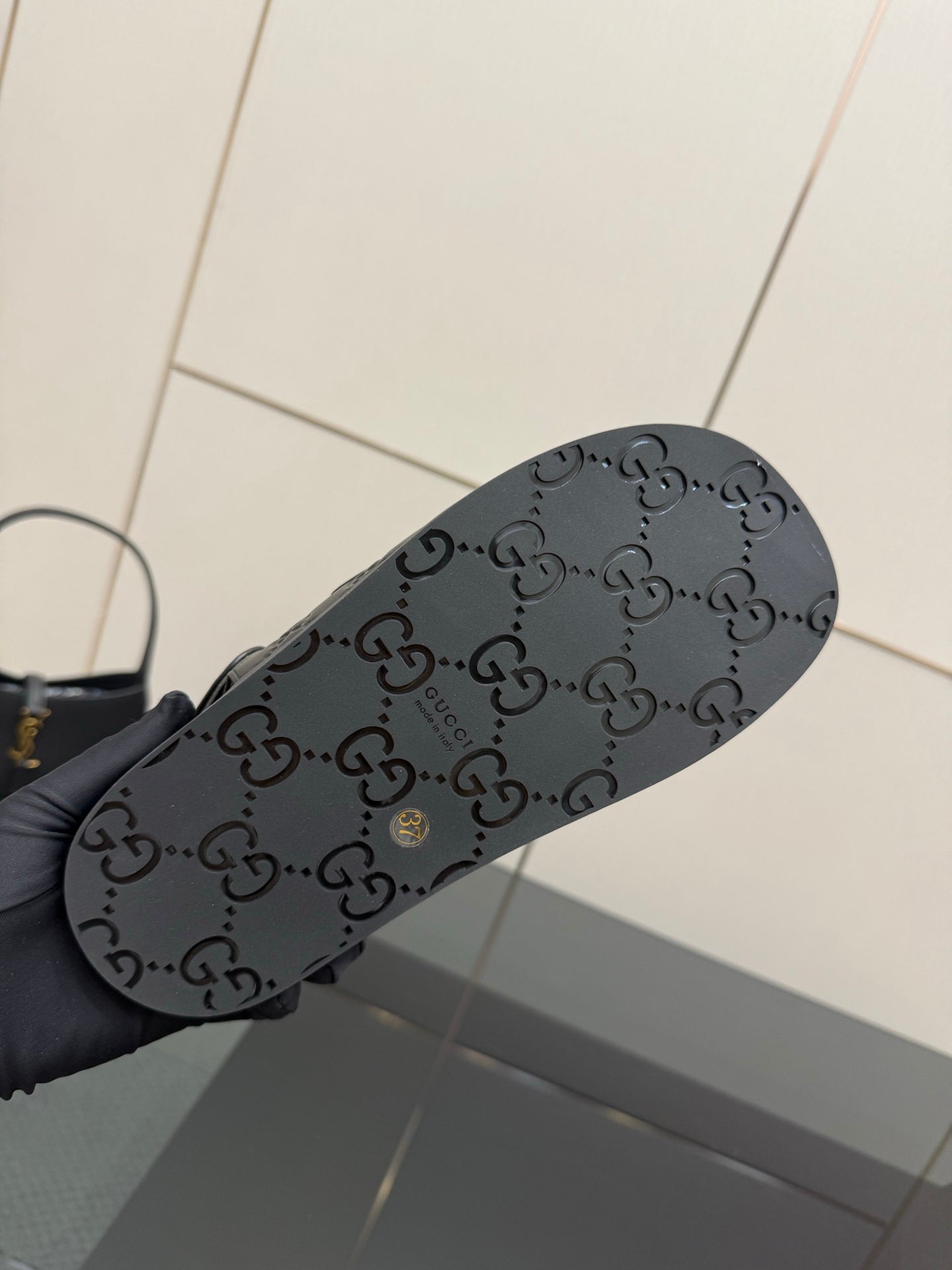 Gucci women's black sandals outsole with logo pattern and textured tread
