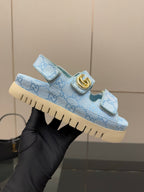 Gucci ladies light blue GG-pattern sneaker held up, gold buckle strap detail