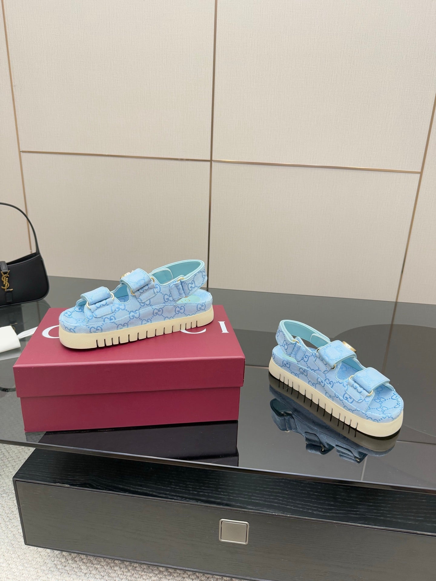 Gucci ladies light blue GG-pattern sneakers, side view with gold buckle and textured sole