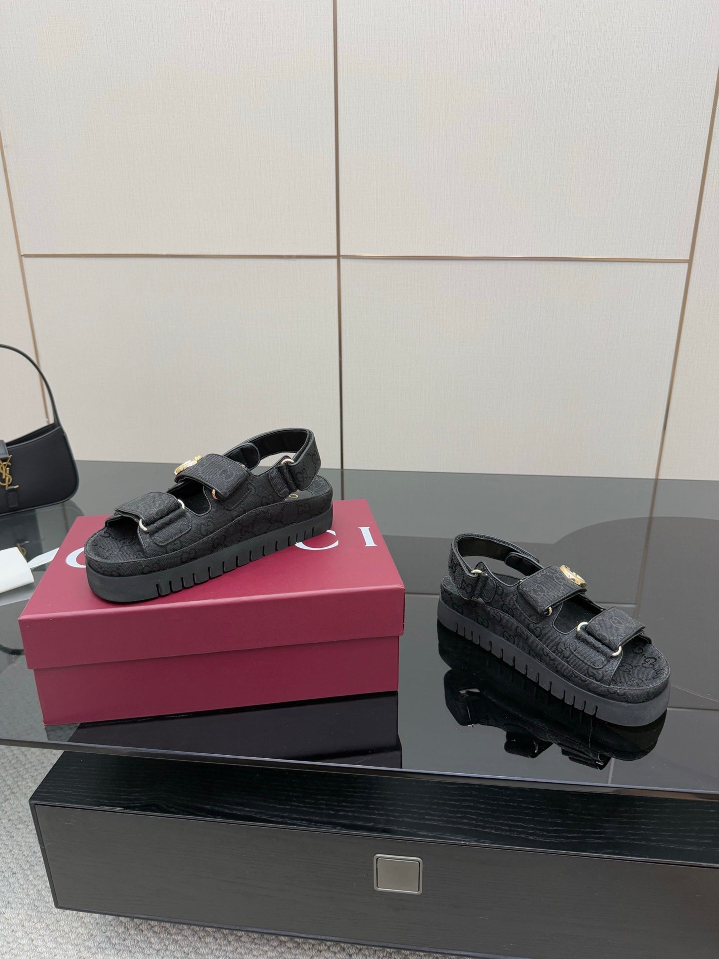 Gucci ladies platform sandals side-by-side, dark GG-pattern straps with gold-tone buckle