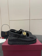 Gucci ladies platform sandals with black GG-pattern upper, front strap, and gold-tone logo buckle