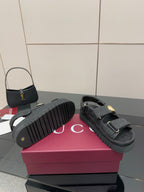 Gucci ladies platform sandals with dark soles and GG-pattern straps, gold-tone buckle detail