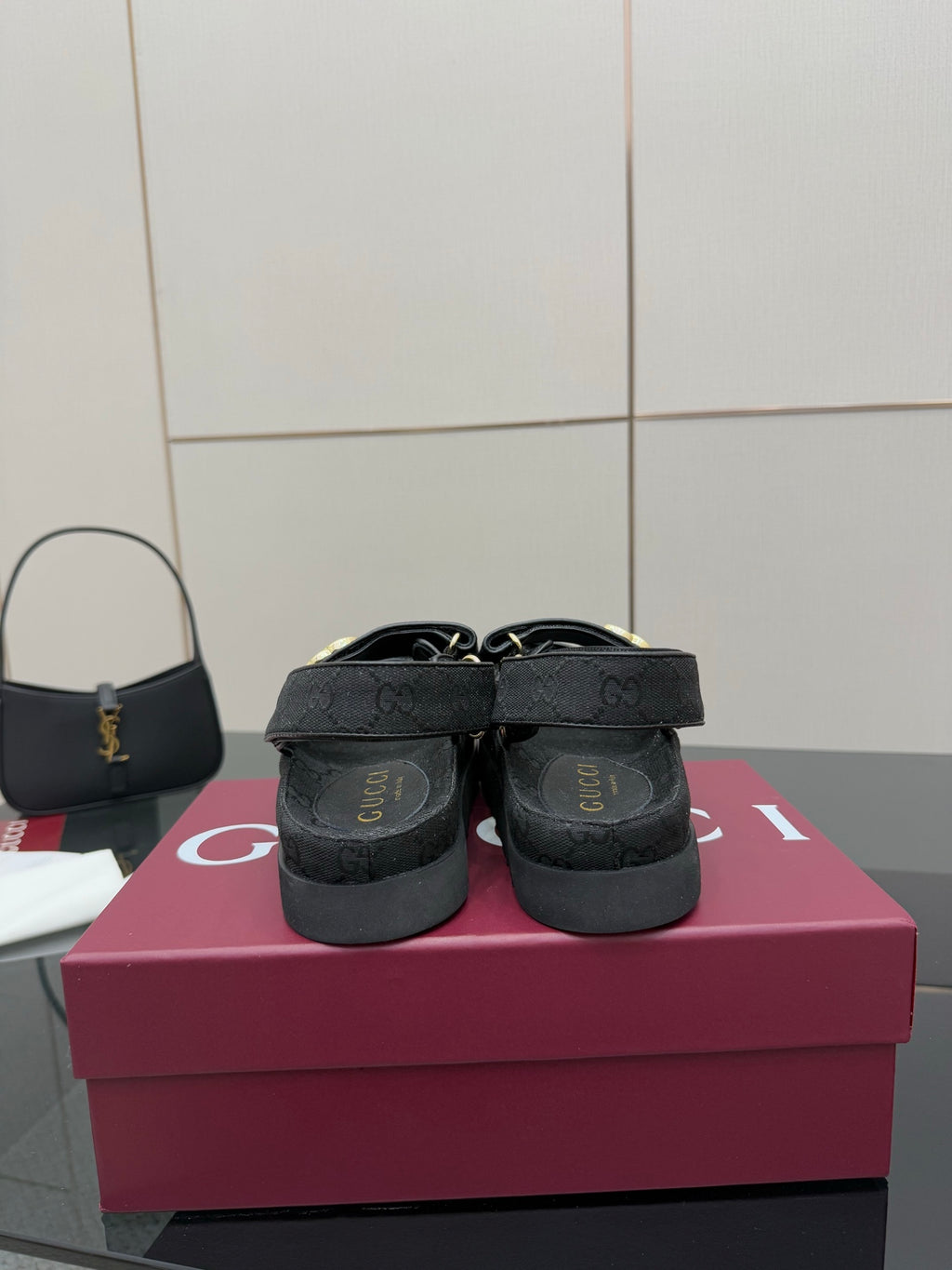 Gucci ladies platform sandals showing back view, dark GG-pattern straps and cushioned heel