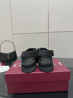 Gucci ladies platform sandals showing back view, dark GG-pattern straps and cushioned heel