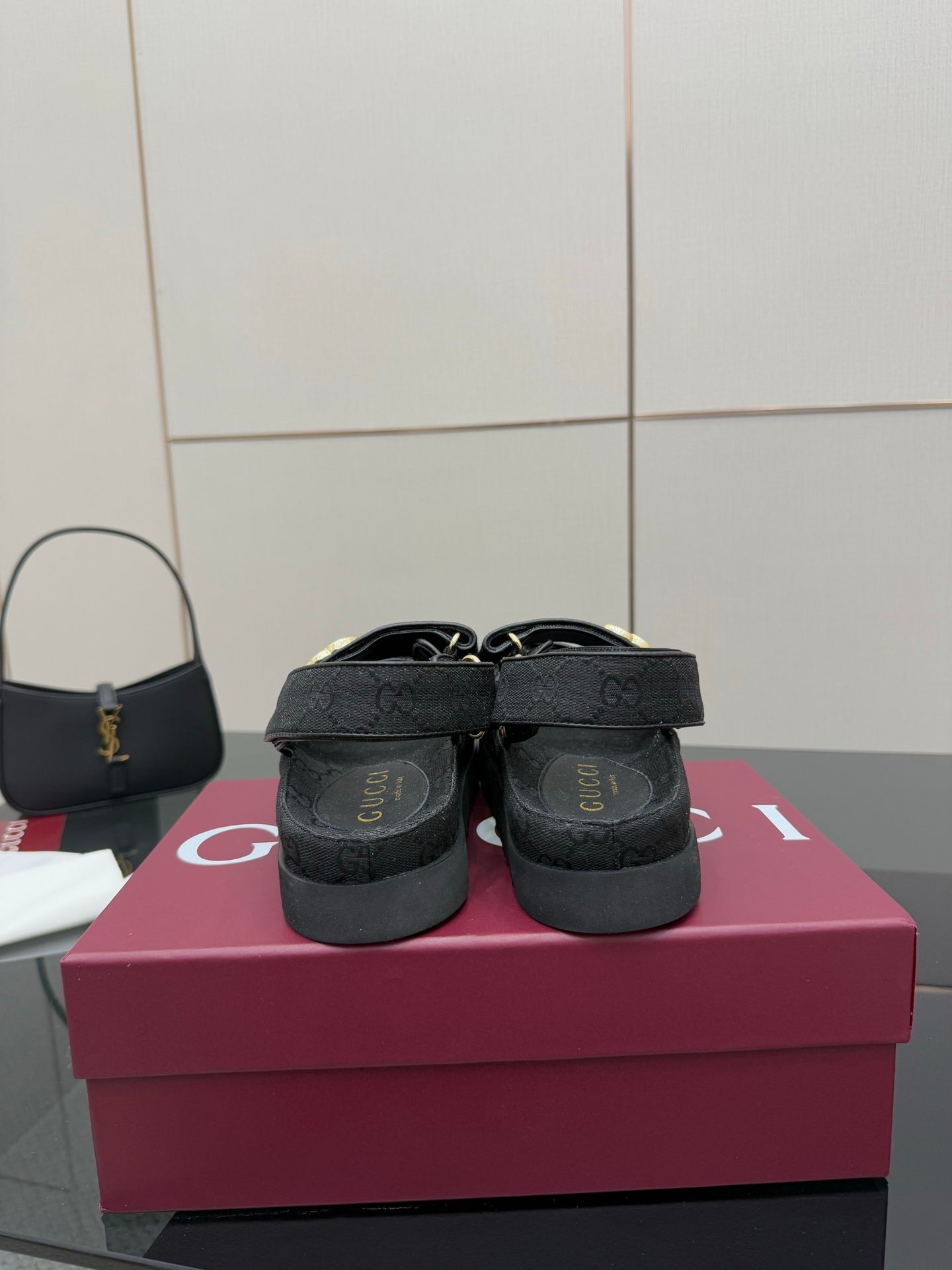 Gucci ladies platform sandals showing back view, dark GG-pattern straps and cushioned heel