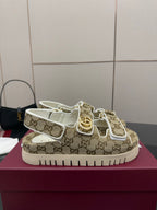 Gucci women’s beige GG canvas sneakers with gold detail and white rubber sole