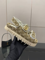 Gucci women’s sneakers held up: beige GG canvas with gold accent and white sole