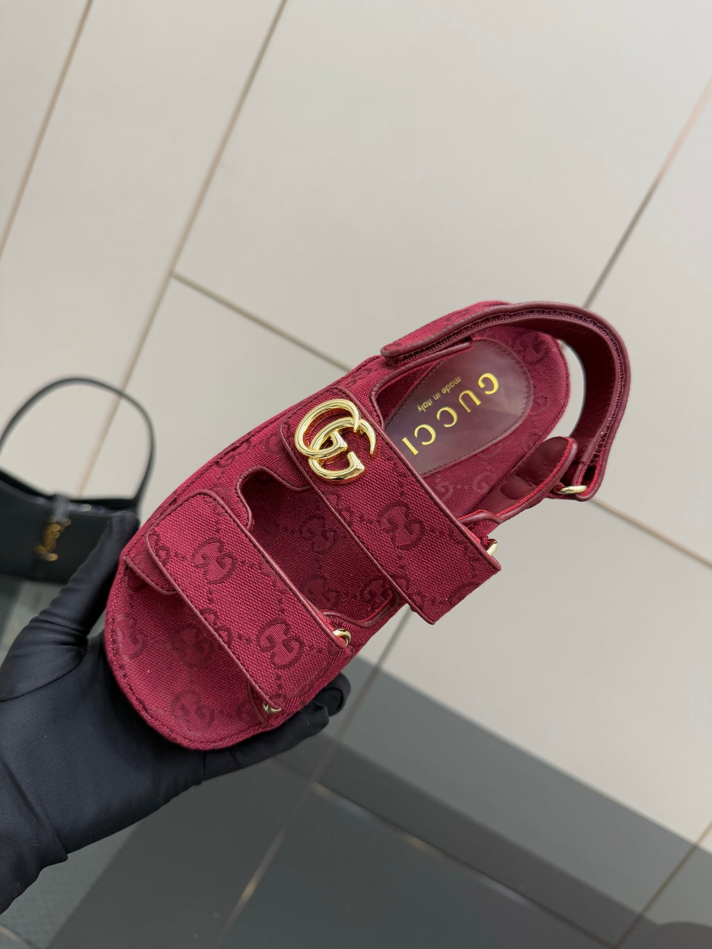 Gucci women’s fuchsia platform sneaker, side view with gold G buckle and GG monogram