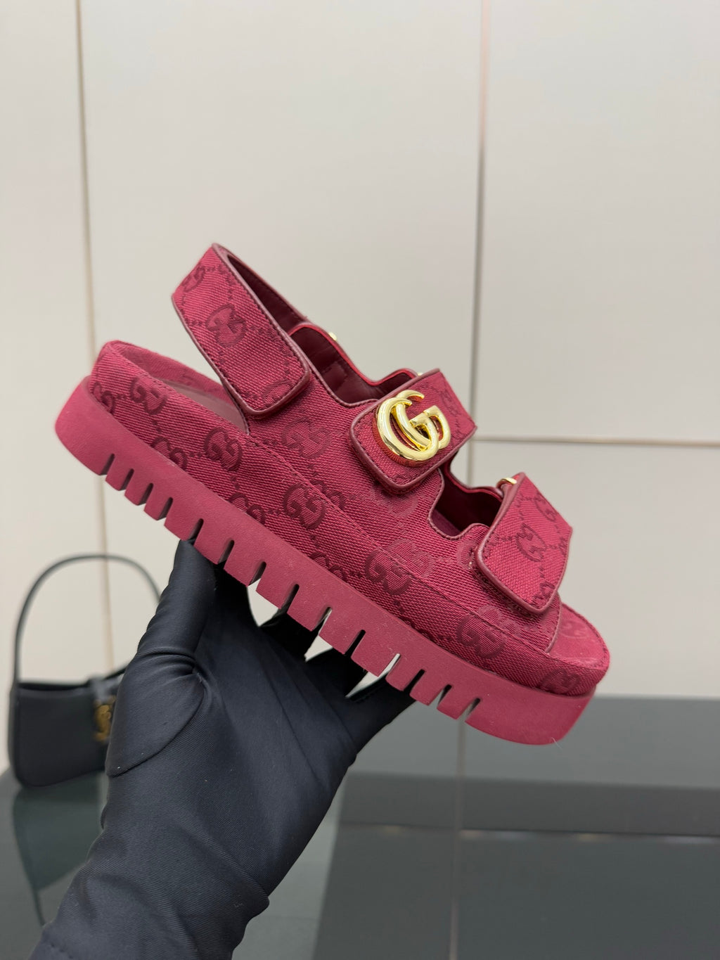 Gucci women’s fuchsia platform sneakers held up, GG monogram upper and gold logo strap