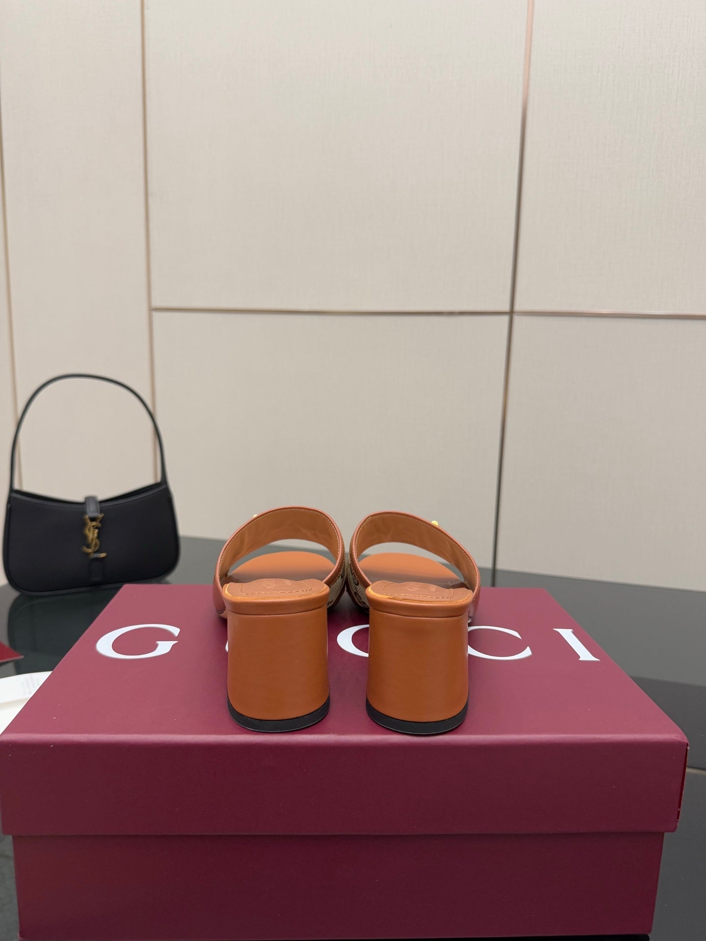 Women's Gucci tan block-heel slide sandals from the back, showing heel profile