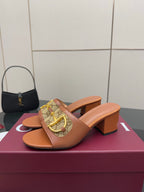 Pair of women's Gucci tan mule sandals with logo-patterned strap and chunky heel