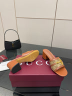 Women's Gucci mule sandals with tan patterned strap and mid block heel