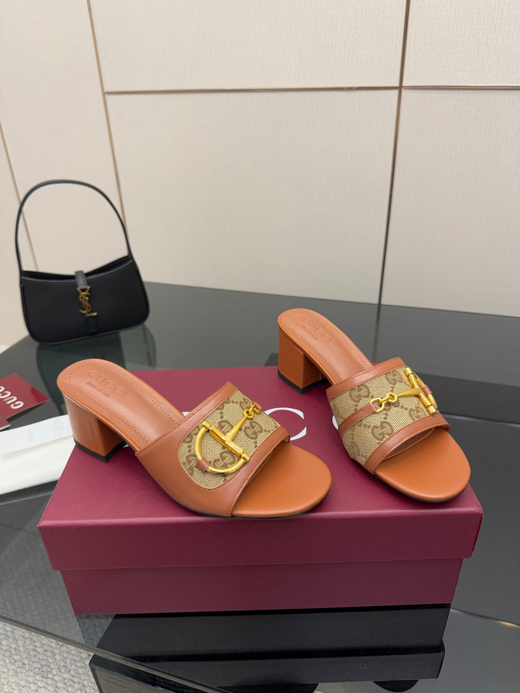 Women's Gucci tan slide sandals with gold horsebit over logo-patterned strap