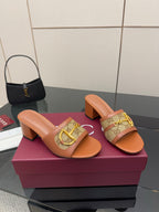Women's Gucci tan slide sandals with gold horsebit over logo-patterned strap