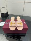 Gucci women’s mule slides in light pink with gold buckle detail and open toe