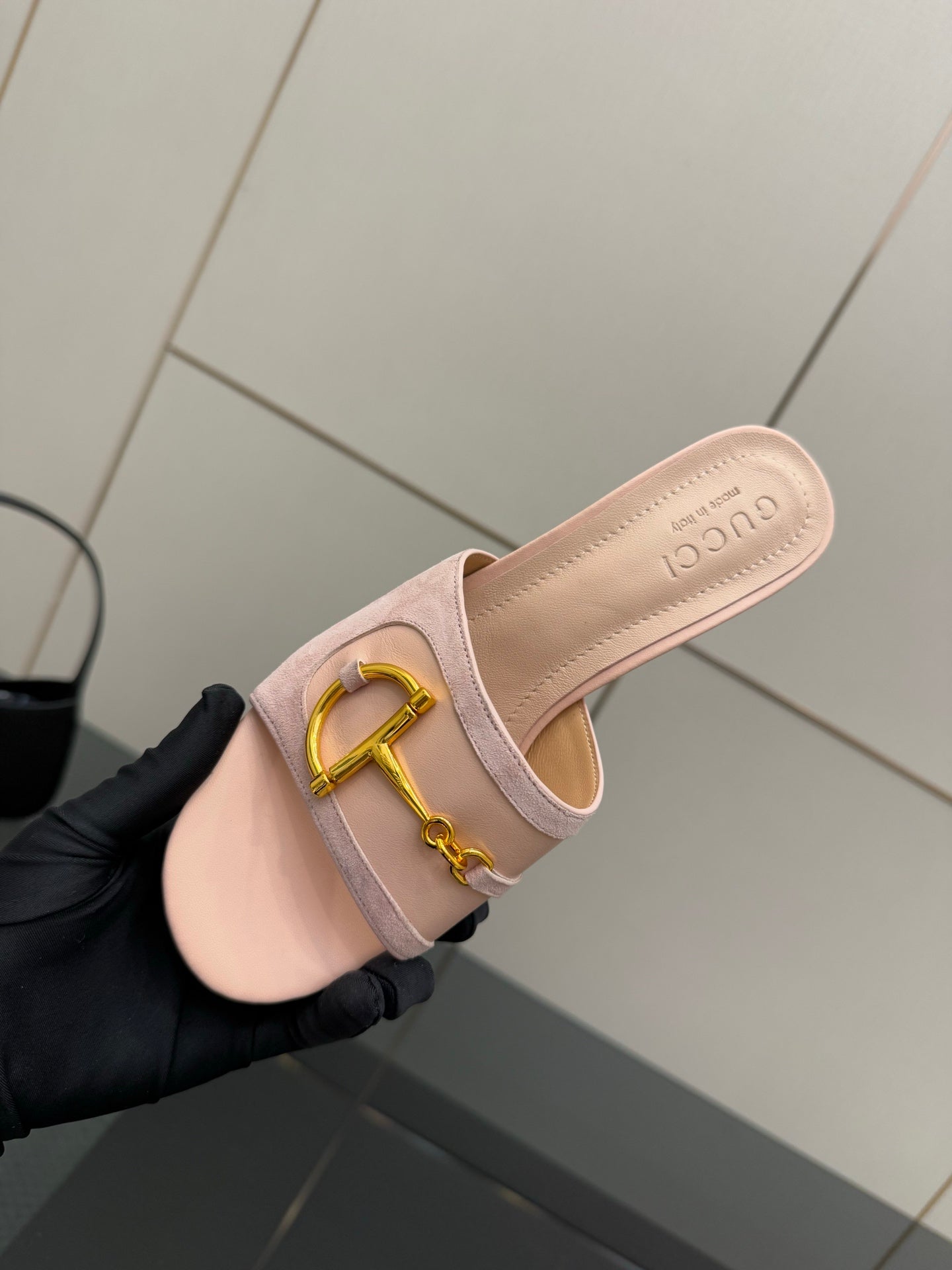 Gucci women’s mule slides, light pink back view with gold buckle and heel detail