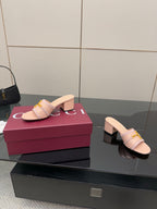 Gucci women’s slide mules, light pink with gold buckle, shown from side on display box