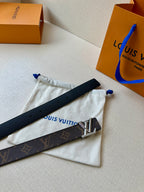 Brown monogram leather belt with gold-tone buckle on drawstring pouch