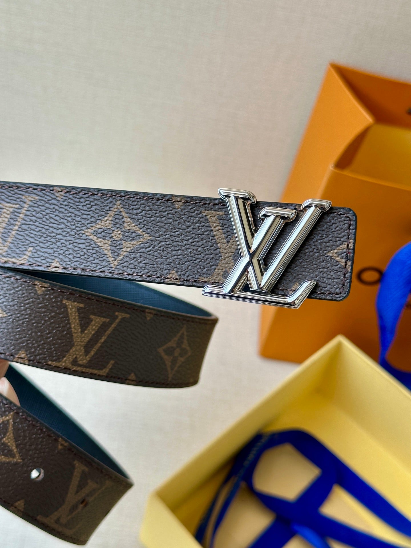 Blue monogram leather belt with large gold-tone LV-style buckle centerpiece